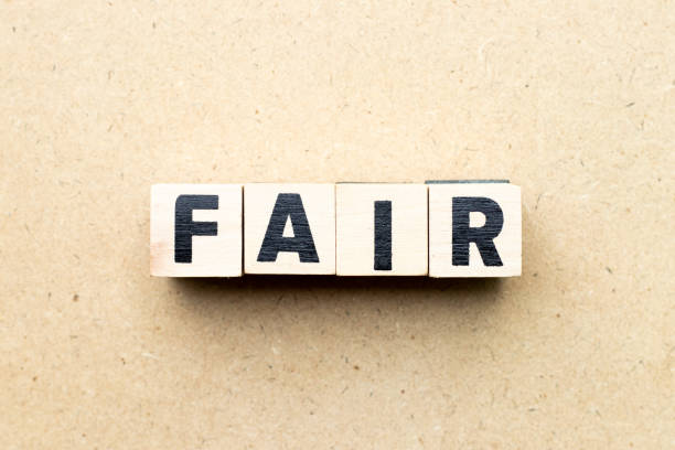 istock Letter block in word fair on wood background 1173370137