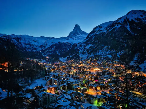 World famous Zermatt town with Matterhorn peak in Mattertal, Valais canton, Switzerland, at dusk in winter.