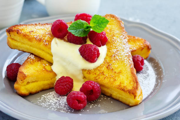 istock French toast with english sauce and raspberries. 1173373048