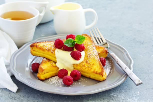 istock French toast with english sauce and raspberries. 1173374347