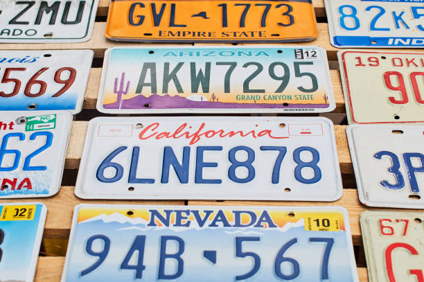 Old discontinued car license plates or vehicle registration numbers from different USA states such as California, Nevada, Arizona. stock photo
