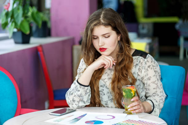 istock Smart serious girl student thinks about the project. Citrus tea with mint. The concept of work, business, education, freelance, lifestyle 1173375271