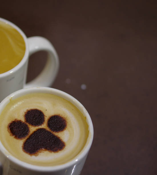 istock Dog paw pattern latte art coffee in white mug at pet cafe 1173375690