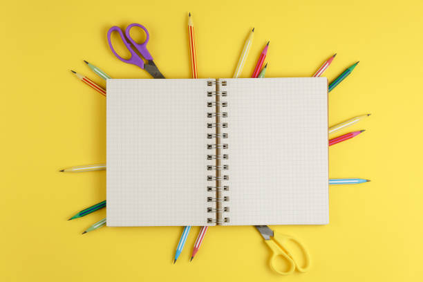 istock notebook on a yellow isolated background, office supplies 1173377253