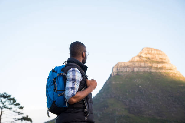 istock Hiker looking at mountain peak against clear sky 1173377502