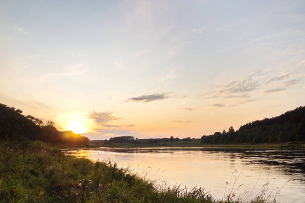 istock Sunset by the river in the summer countryside 1173378467