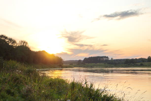 istock Sunset by the river in the summer countryside 1173378535