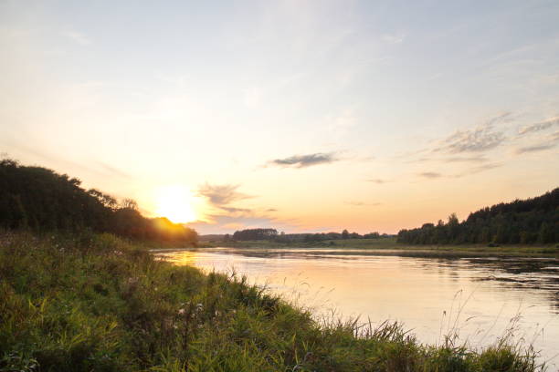 istock Sunset by the river in the summer countryside 1173378552
