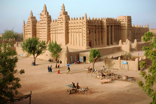 The great Mosque in the Sahara desert city of Djenné in Mali, West Africa near Timbuktu - the largest mud (adobe) building in the world
The Great Mosque of Djenné is a large banco or adobe building that is considered by many architects to be one of the greatest achievements of the Sudano-Sahelian architectural style. The mosque is located in the city of Djenné, Mali, on the flood plain of the Bani River. The first mosque on the site was built around the 13th century, but the current structure dates from 1907.