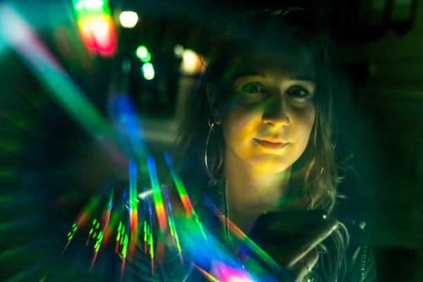 istock Beautiful young woman's portrait with rainbow light reflections 1173380281