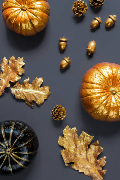 istock Flat lay autumn composition.Pumpkins, leaves, acorns, golden cones on a gray background Frame copy space. Template fall harvest thanksgiving halloween anniversary  cards Top view 1173382507