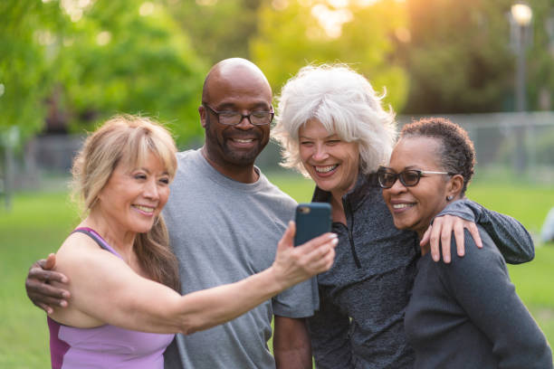 istock Multi-ethnic group of senior friends pose for selfie outside 1173387650