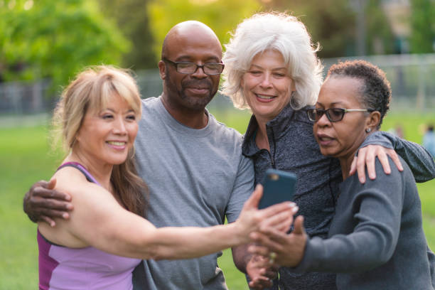 istock Multi-ethnic group of senior friends pose for selfie outside 1173387664