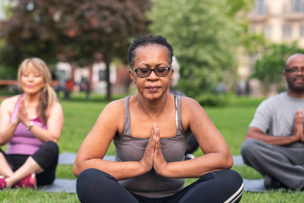 istock Multi-ethnic group of seniors meditating outdoors 1173387700