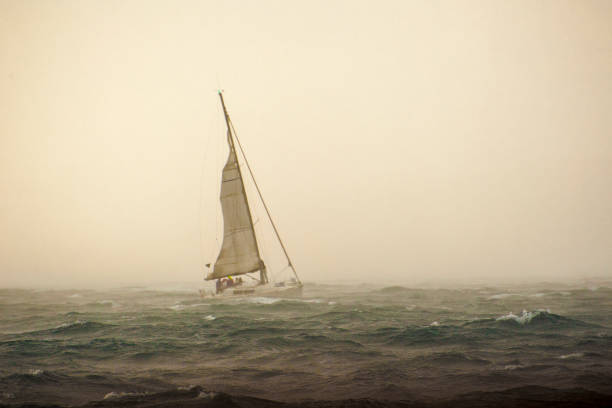 Sailboat in silhouette at sunrise