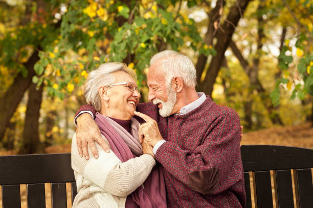 istock Romantic and love senior couple on a park bench 1173389193
