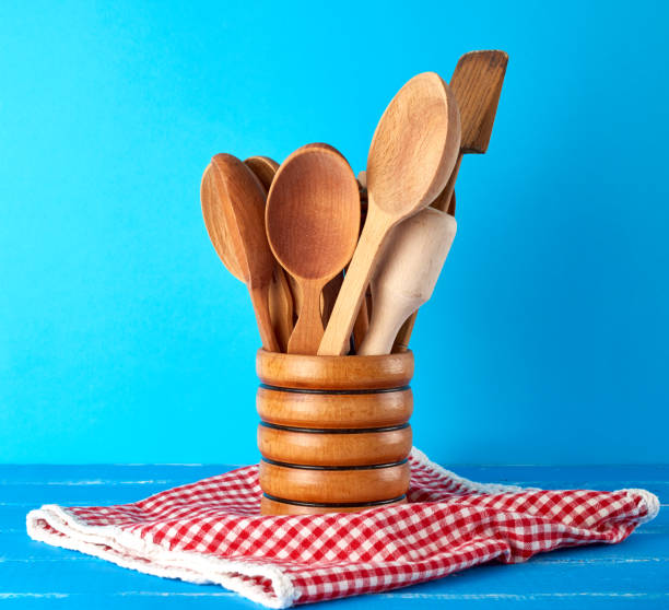 istock wooden spoons in a wooden container on a blue table 1173394376