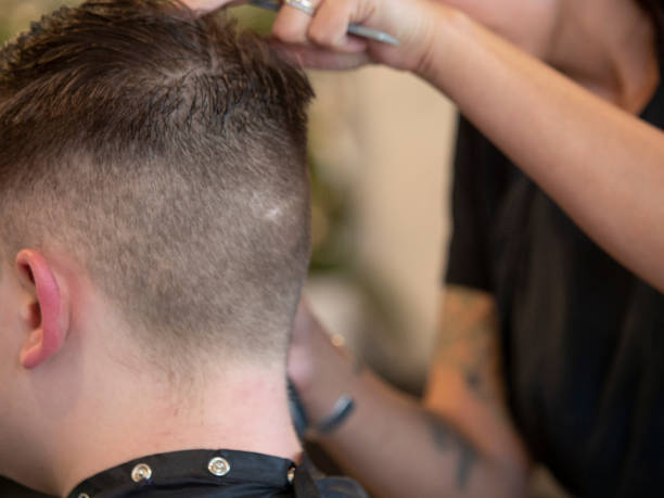 istock Stylist trimming hair 1173394591