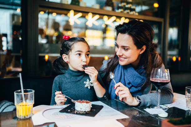 istock Family eating in restaurant 1173394702