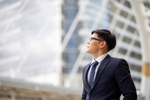 istock Businessman Looking Away While Standing Against Building In City 1173396257