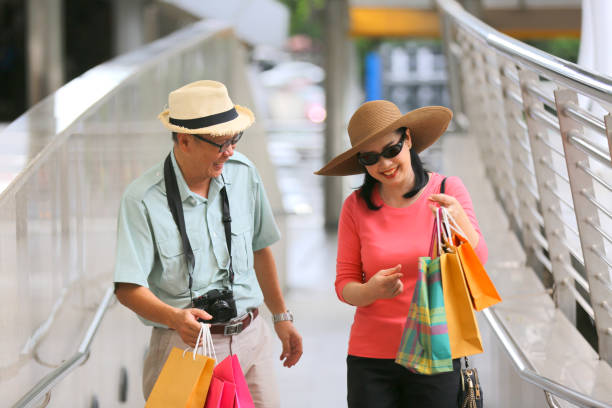 istock Smiling Couple Holding Shopping Bags 1173398013