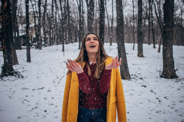 istock Pretty woman having fun with snow 1173403357