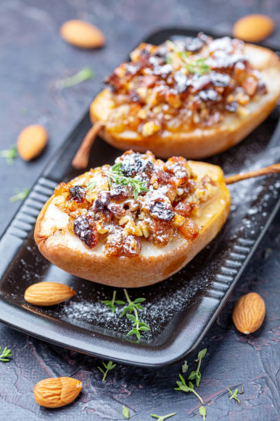 istock Pears baked in honey with raisins and nuts. 1173403414