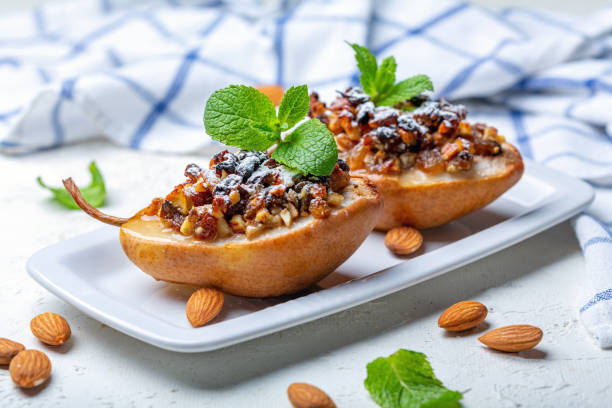 istock Pears baked with raisins, nuts, honey and mint. 1173403461