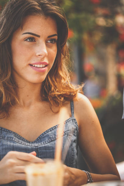 istock Pretty girl enjoying coffee outside 1173404305