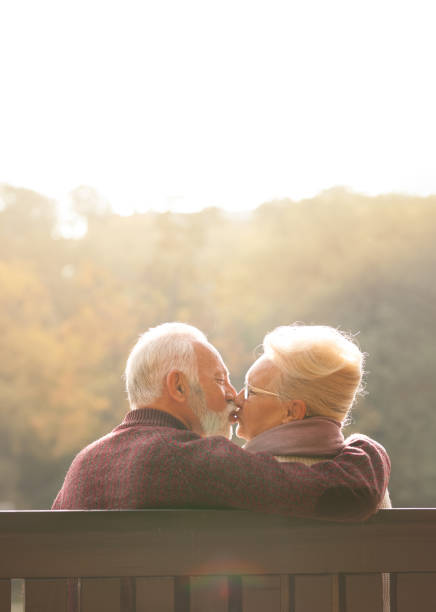 istock Senior couple kissing over sunny day 1173404890