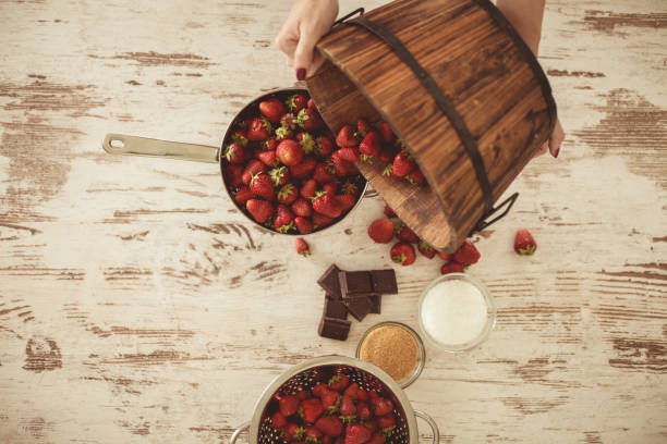 Cropped view of woman handling strawberries