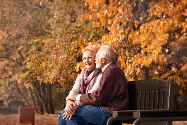 istock Senior couple flirting on bench 1173404976