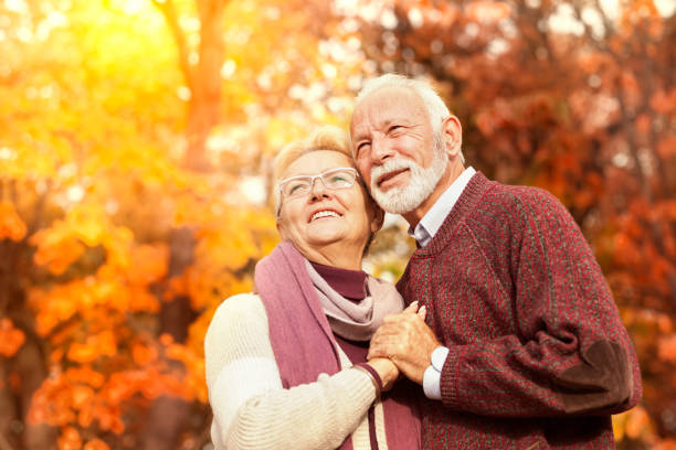 istock Happy senior couple in an autumn forest 1173405666