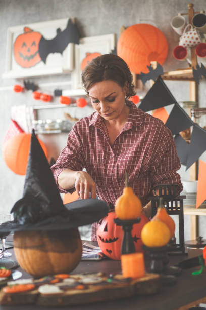 istock Older woman prepares decorations 1173405910