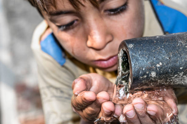 istock a young thirsty boy is drinking clean and sweet water 1173410500