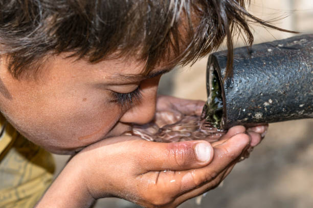 istock a young thirsty boy is drinking clean and sweet water 1173410707