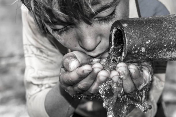 istock a young thirsty boy is drinking clean and sweet water 1173410714
