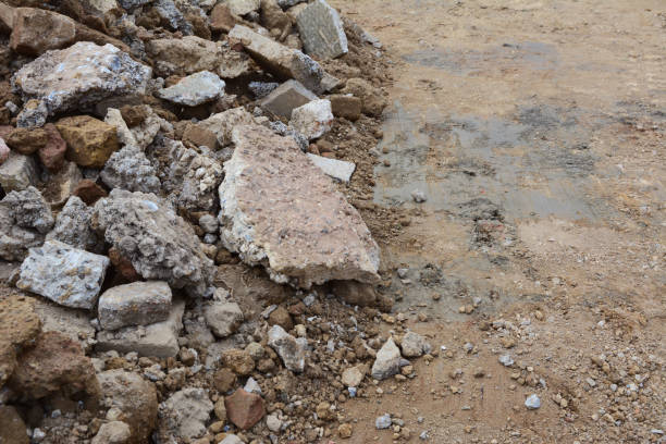 istock Broken pieces of concrete and bricks next to excavated ground 1173411772