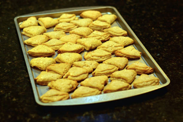 istock Freshly baked yellow cookies on a baking sheet, closeup. 1173413968