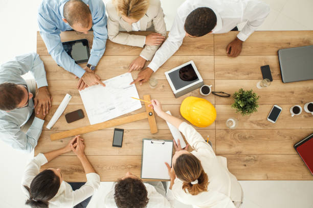 istock Aerial view of engineers discussing design plans 1173415684