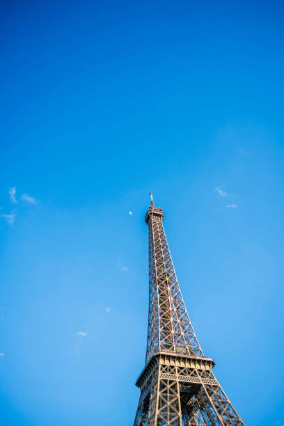 The unique iconic famous Eiffel Tower with spring moon, as a symbol and main landmark of Paris and the French inventive genius in the historical past, attracts thousands of tourists with its fame