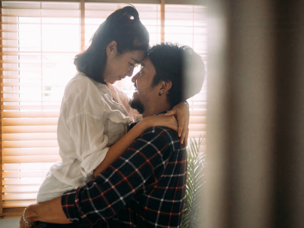 istock Man holding woman near moving boxes 1173416371