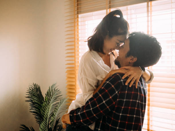 istock Man holding woman near moving boxes 1173416382