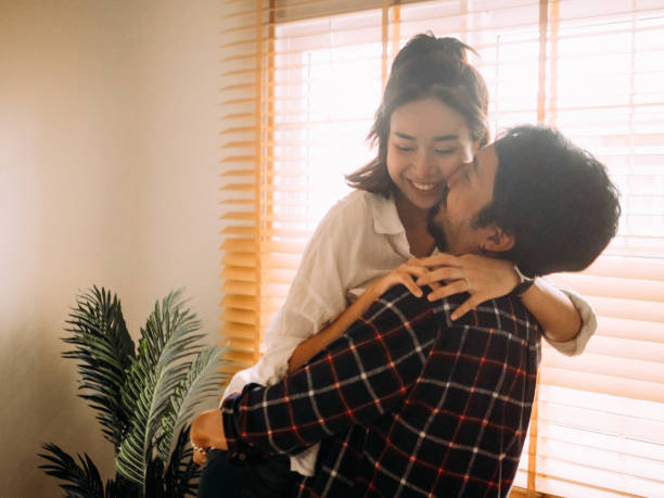 istock Man holding woman near moving boxes 1173416424