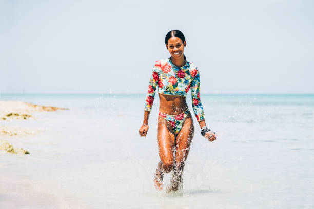 istock Young Black woman at tropical beach 1173416479