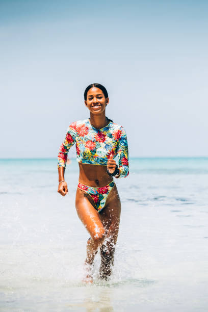 istock Young Black woman at tropical beach 1173416514