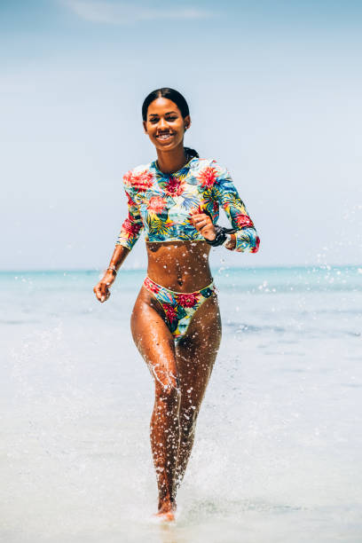 istock Young Black woman at tropical beach 1173417128