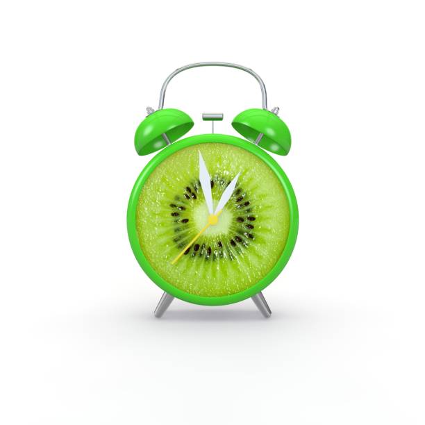 istock Kiwi slice alarm clock on white background 1173427042