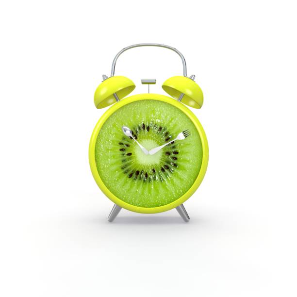 istock Kiwi slice alarm clock on white background. Minimal business concept 1173427153