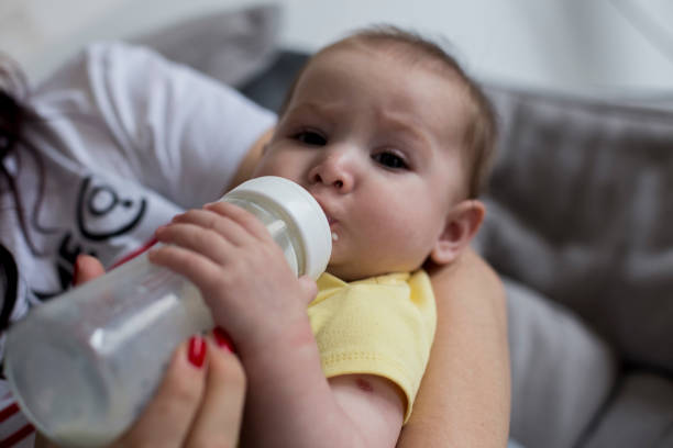 istock A beautiful and young mother feeds her baby from a bottle with a pacifier 1173427610